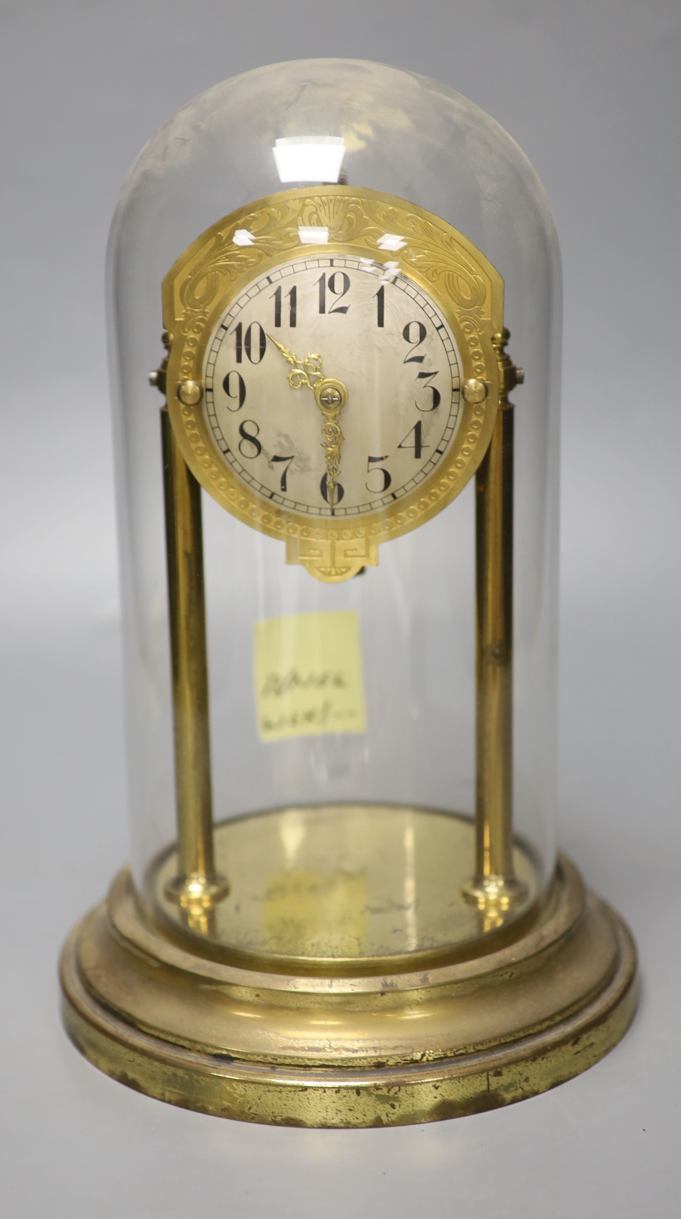 A brass electric mantel clock, under a glass dome, overall height 30cm